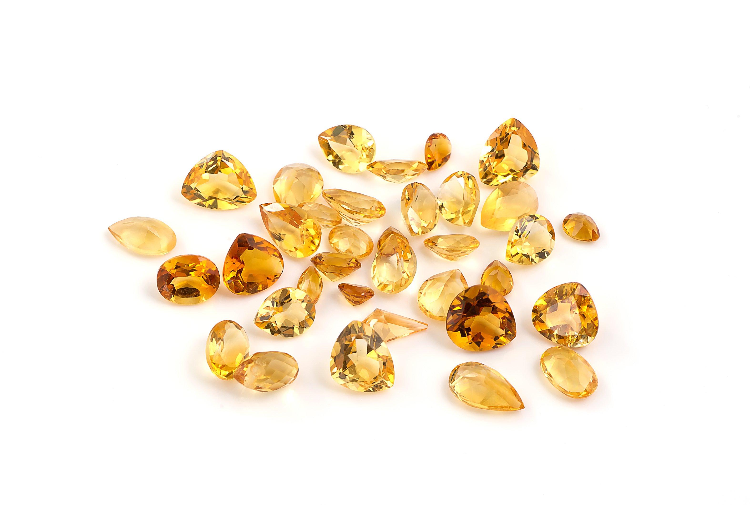 Group of citrine gemstones on white.